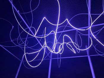 Full frame shot of illuminated light painting against black background