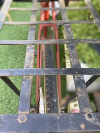 Close-up of fence against railing