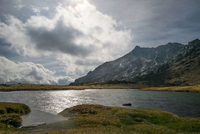 Scenic view of lake and mountains against sky