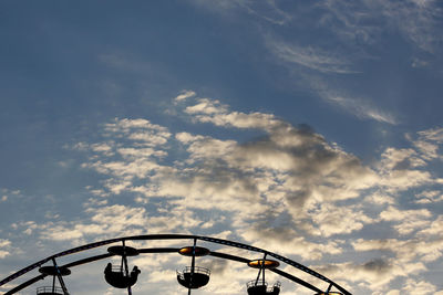 Low angle view of ferris wheel against sky