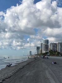 Panoramic view of beach and buildings against sky