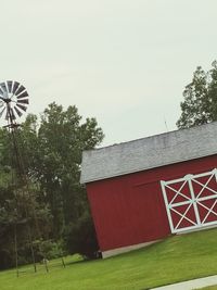 Low angle view of traditional windmill against clear sky