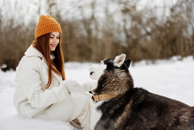 Smiling young woman with dog