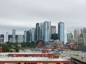 Modern buildings in city against sky