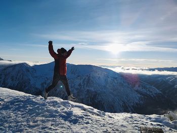 Full length of man man walking on snow against sky during winter