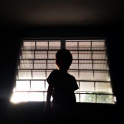 View of woman in the dark