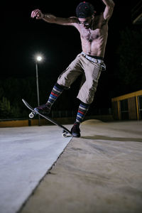 Young white man jumping on his skateboard