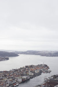 High angle view of sea and cityscape against sky