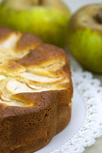 Close-up of fruits by cake on table