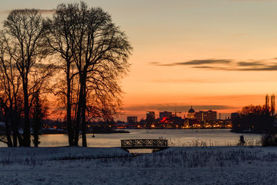 Scenic view of lake against sky during sunset