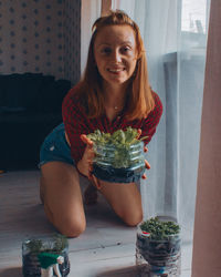 Portrait of a smiling young woman at home