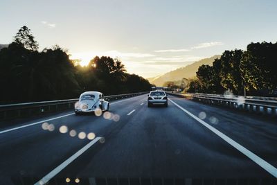 Road passing through sunset