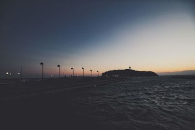 Scenic view of sea against clear sky at dusk