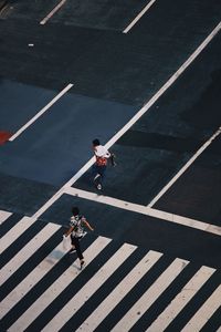 High angle view of people crossing road