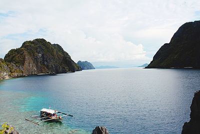 Scenic view of sea with mountain range in background