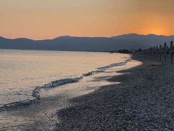 Scenic view of beach against sky during sunset