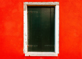 Close up of window on red housing wall