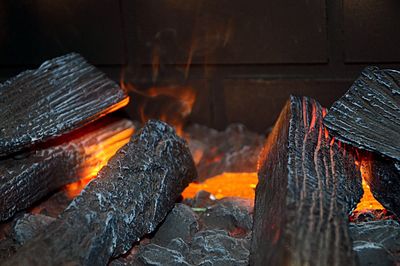 Close-up of firewood at fireplace