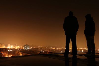 People standing in city at night