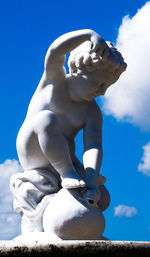 Low angle view of statue against blue sky