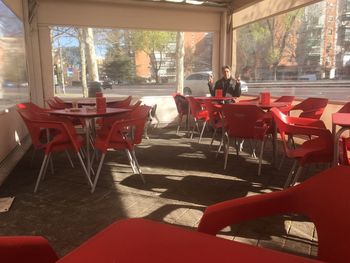 Empty chairs and tables in restaurant