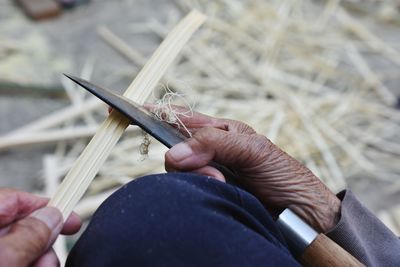 Close-up of hand making craft product