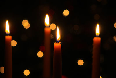 Close-up of lit candles in temple