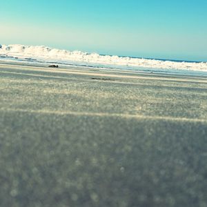 Surface level of sea against clear sky