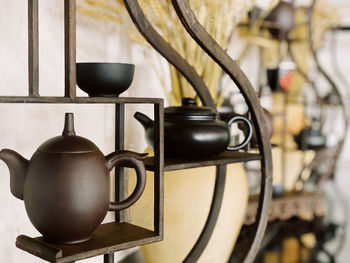 Close-up of teapot on shelf