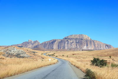 Scenic view of road against clear blue sky