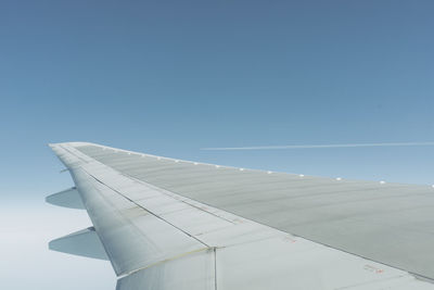 Airplane wing against sky