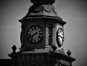 Low angle view of clock tower against sky