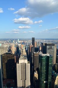 Aerial view of buildings in city against sky