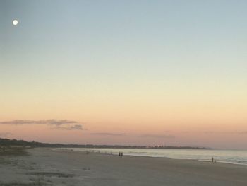 Scenic view of beach against sky during sunset