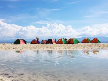 View of people on beach against sky