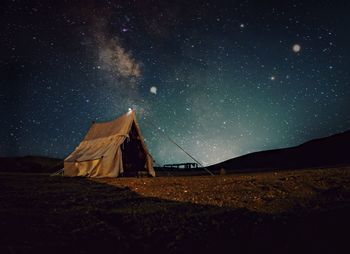 Tent on field against sky at night