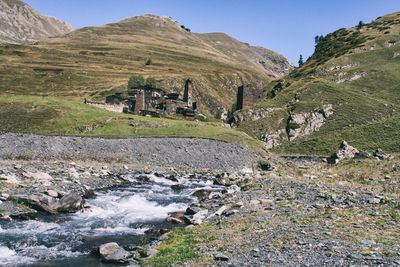 Scenic view of waterfall against sky