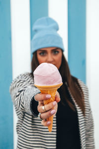 Portrait of woman holding ice cream cone