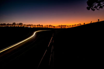 Panoramic view of silhouette road against sky during sunset