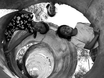 Low angle view of smiling children against sky