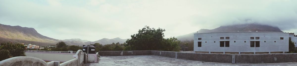 Panoramic view of building against cloudy sky