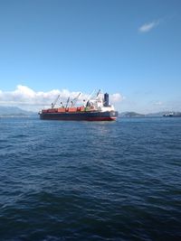 Ship sailing on sea against sky