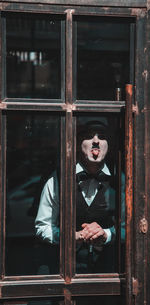 Woman looking through window