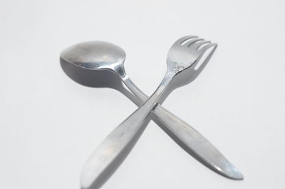High angle view of spoon on table against white background