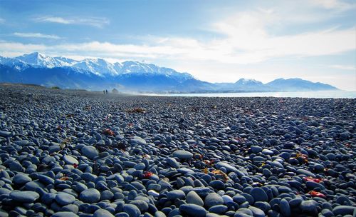 Pebbles on beach against sky