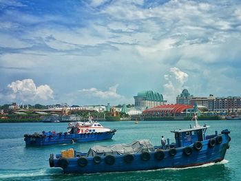 Boats in sea with boats in background