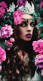 Close-up portrait of woman with pink flowers