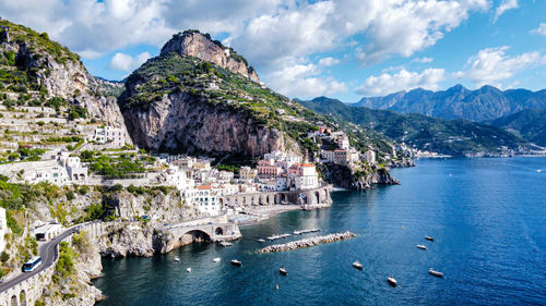 Scenic view of sea and mountains against sky