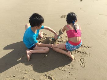 Children playing on sand at beach