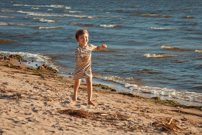 Full length of girl standing on beach